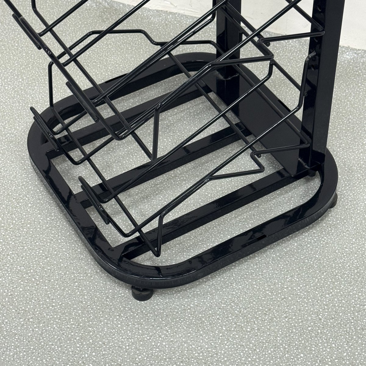 Welded steel base of the newspaper display rack with lockable caster wheels